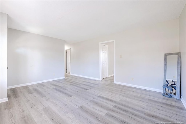 spare room with light hardwood / wood-style floors