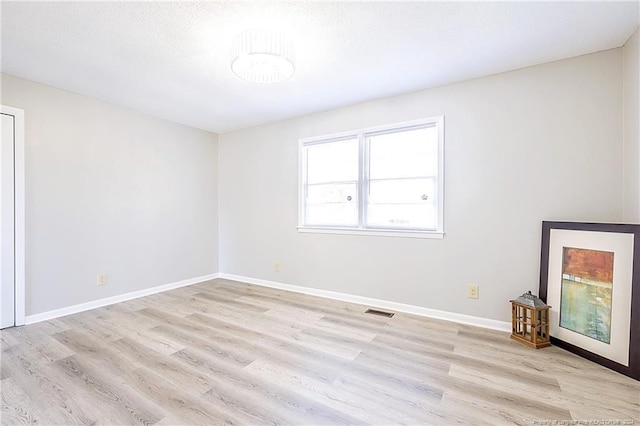 unfurnished room with light hardwood / wood-style flooring