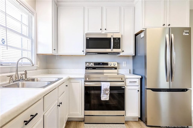 kitchen featuring sink, white cabinets, and appliances with stainless steel finishes