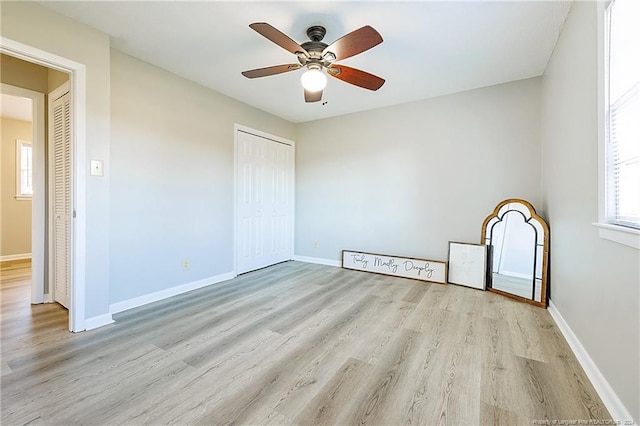 unfurnished bedroom with ceiling fan, a closet, and light hardwood / wood-style floors