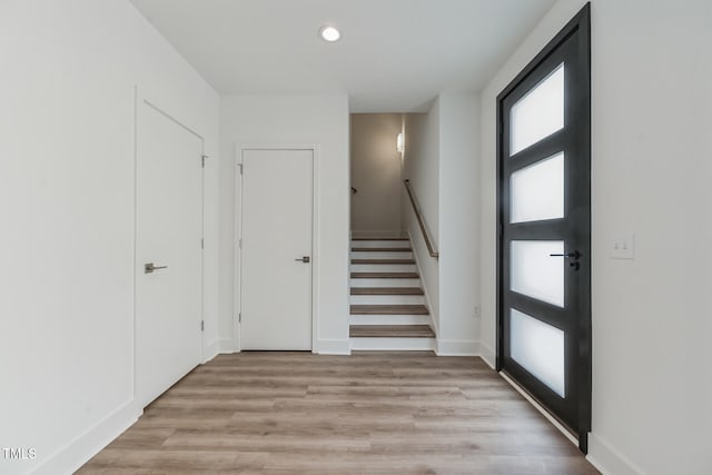 foyer entrance with light wood-type flooring