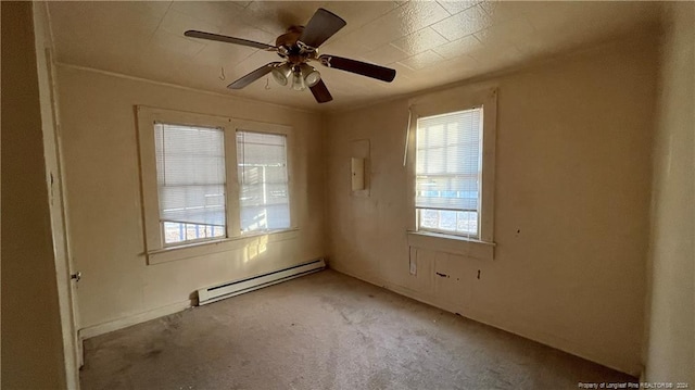 carpeted empty room with a baseboard radiator and ceiling fan