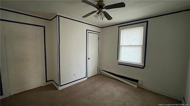 unfurnished bedroom featuring baseboard heating, ceiling fan, and light carpet