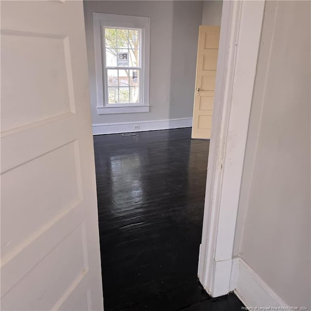 spare room featuring dark wood-type flooring