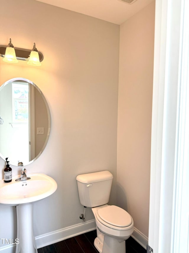 bathroom with sink, wood-type flooring, and toilet