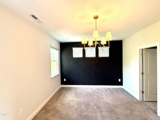 unfurnished dining area with carpet floors and a notable chandelier