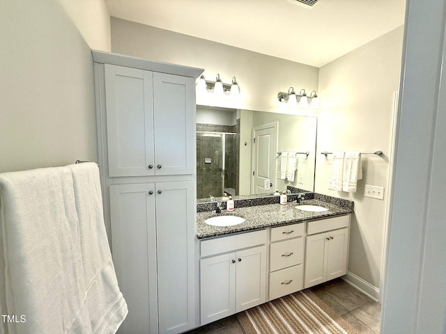 bathroom featuring vanity and a shower with shower door