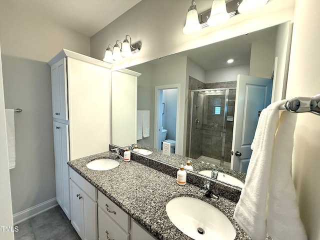 bathroom with vanity, an enclosed shower, and toilet