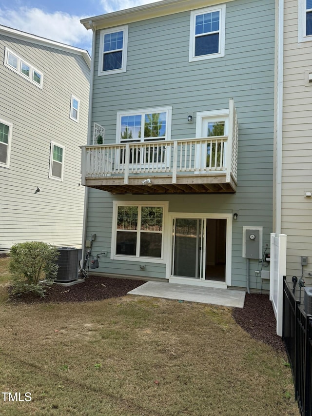 back of property with a yard, a patio, and central air condition unit