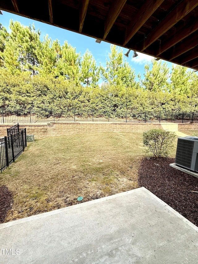 view of yard featuring a rural view, central air condition unit, and a patio