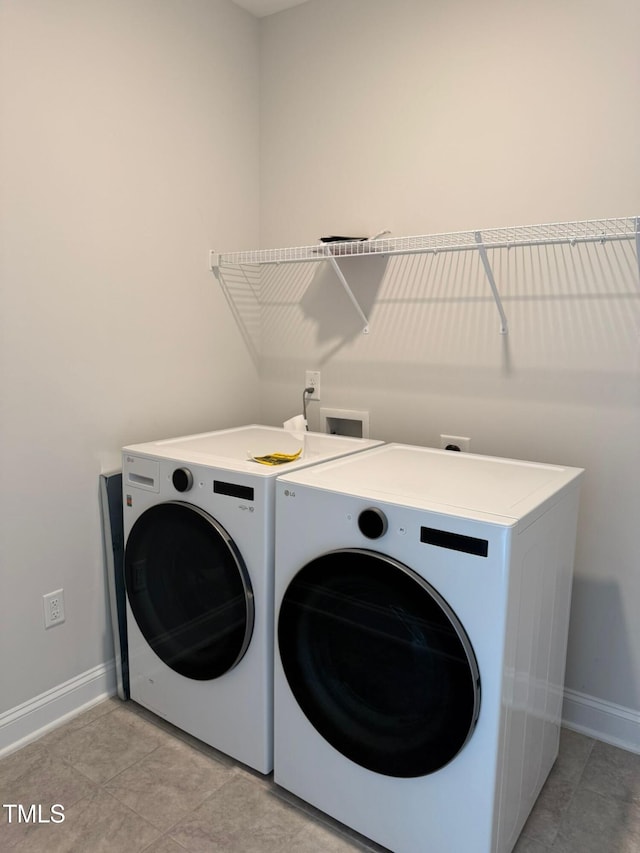 laundry room with light tile patterned floors and separate washer and dryer