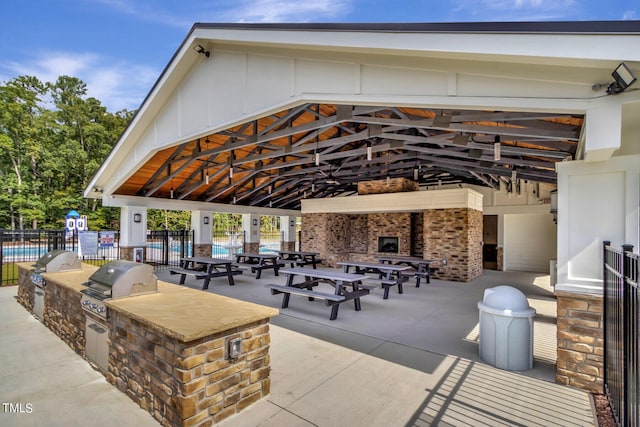 surrounding community with an outdoor kitchen and a patio area