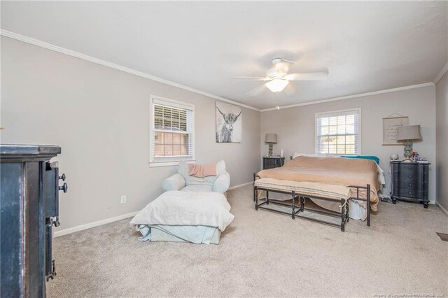 carpeted bedroom featuring ornamental molding and ceiling fan