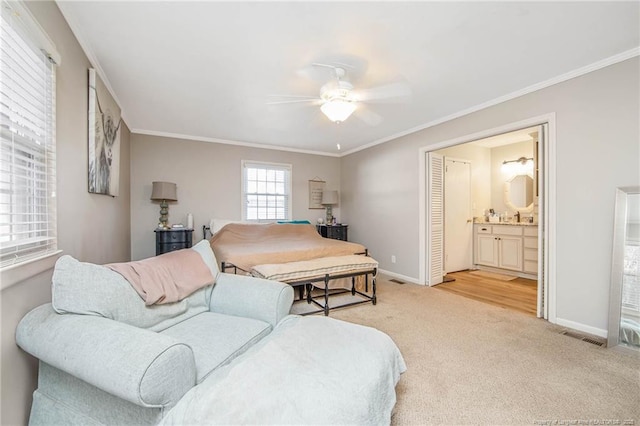 carpeted bedroom featuring ceiling fan, ornamental molding, connected bathroom, and sink