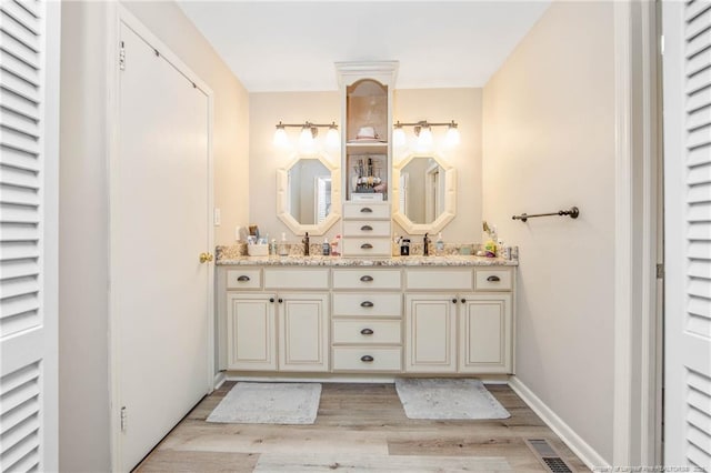 bathroom featuring vanity and hardwood / wood-style floors