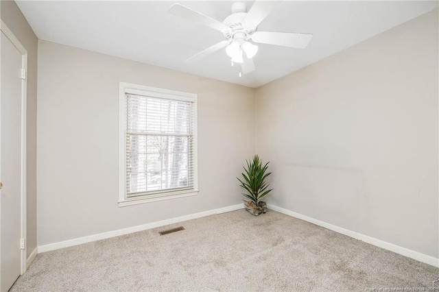 spare room featuring light colored carpet and ceiling fan