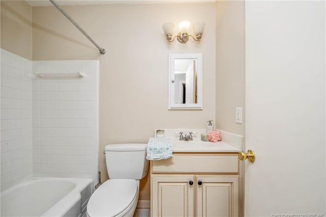 full bathroom featuring vanity, tiled shower / bath combo, and toilet