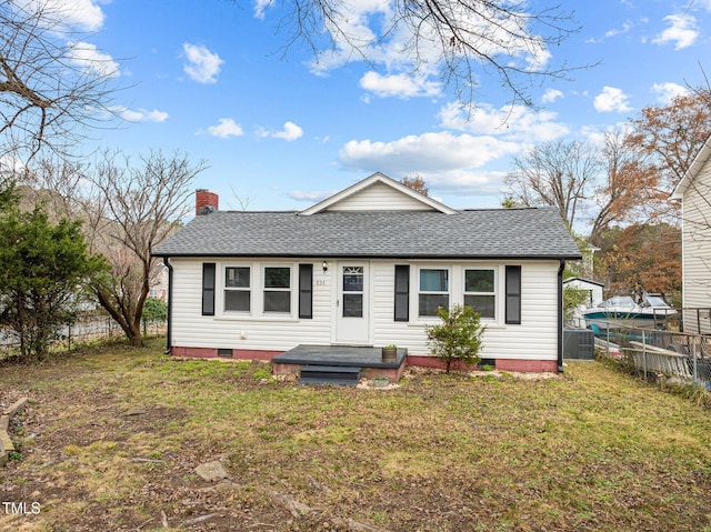 rear view of property with a yard and central AC