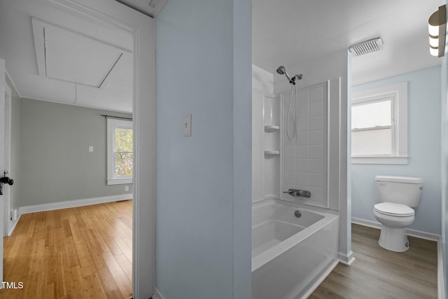 bathroom with shower / tub combination, hardwood / wood-style flooring, and toilet