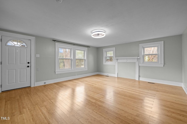 foyer entrance featuring a wealth of natural light and light wood-type flooring