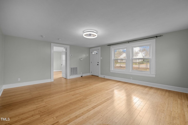 unfurnished living room with light wood-type flooring