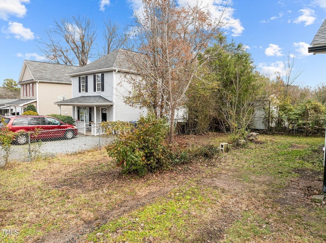 view of side of property with a porch