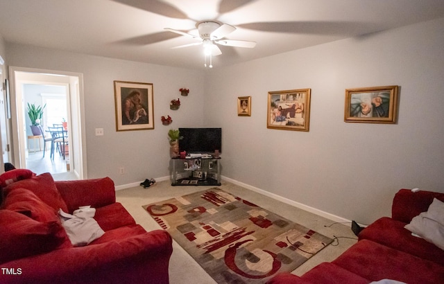 carpeted living room featuring ceiling fan