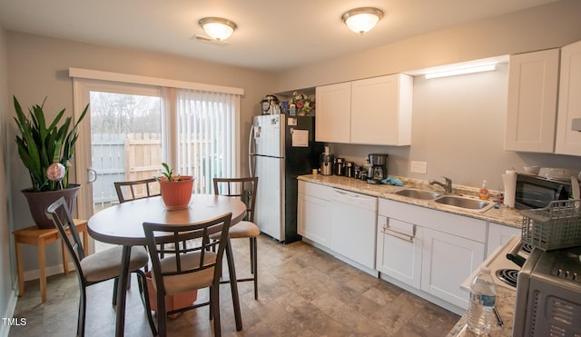 kitchen with white cabinets, dishwasher, and sink