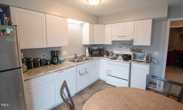 kitchen featuring white cabinetry, sink, light stone counters, and white appliances