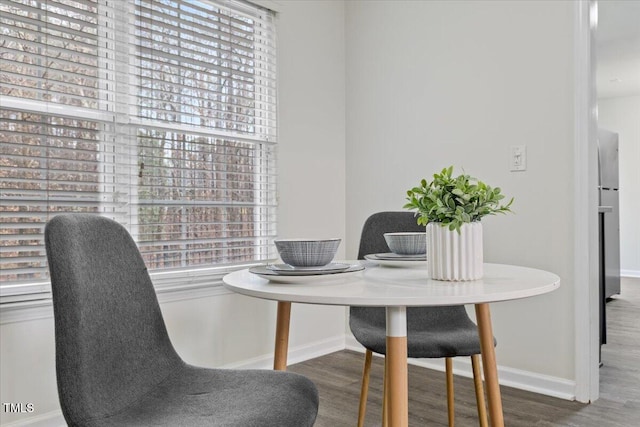 dining area with a healthy amount of sunlight, baseboards, and wood finished floors