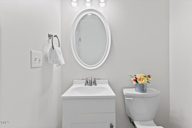 bathroom featuring toilet and vanity