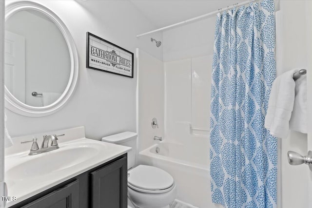 full bath featuring shower / bath combo with shower curtain, vanity, and toilet