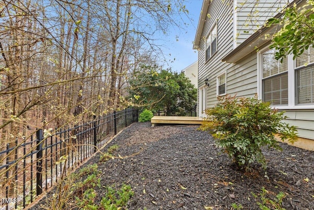 view of yard featuring fence and a wooden deck