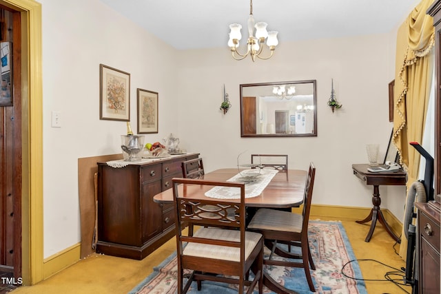 carpeted dining area featuring a chandelier