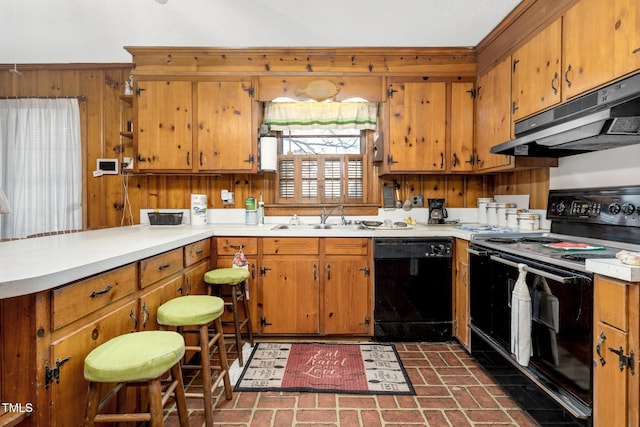 kitchen with exhaust hood, wood walls, sink, and black appliances