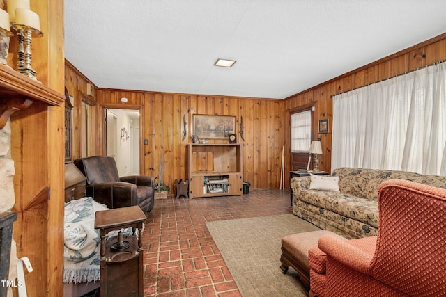 living room featuring ornamental molding and wooden walls