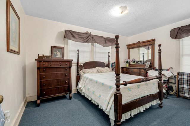 carpeted bedroom featuring a textured ceiling and multiple windows