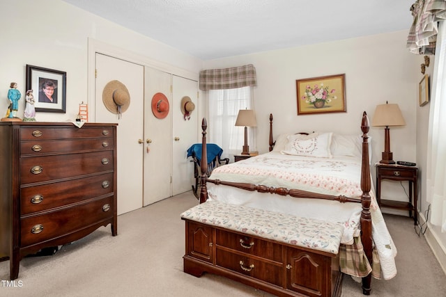 bedroom with a closet and light colored carpet