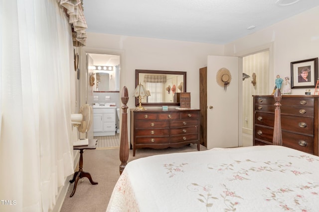 carpeted bedroom featuring ensuite bathroom