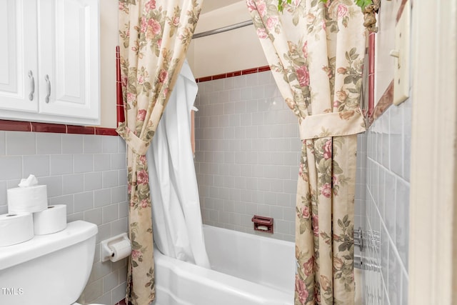 bathroom with shower / tub combo with curtain, tile walls, and toilet