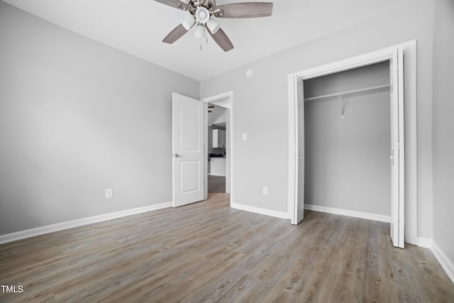 unfurnished bedroom with ceiling fan, a closet, and light hardwood / wood-style floors