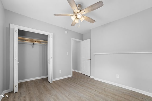 unfurnished bedroom featuring light wood-type flooring, a closet, and ceiling fan