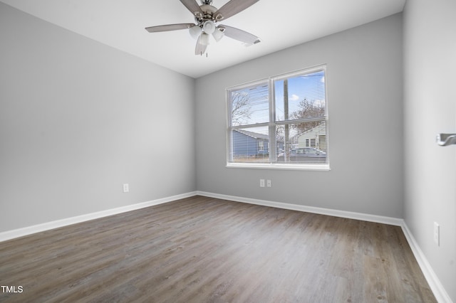 spare room with hardwood / wood-style floors and ceiling fan