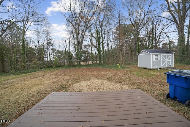 view of yard featuring a storage shed and a deck