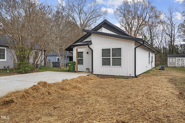 modern farmhouse featuring a storage shed and central air condition unit