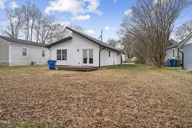 back of house featuring a lawn, a wooden deck, french doors, and cooling unit