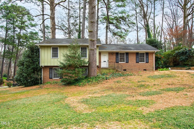 split level home featuring brick siding, crawl space, a front yard, and board and batten siding