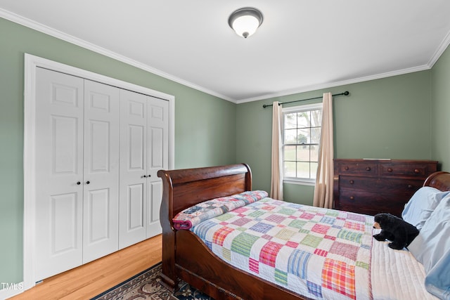 bedroom with a closet, crown molding, and wood finished floors