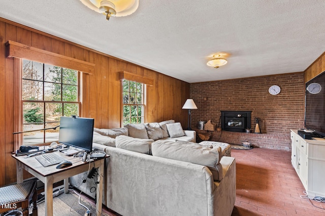 living area featuring brick floor, wood walls, and a textured ceiling