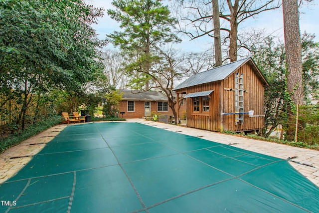 view of swimming pool featuring an outdoor structure